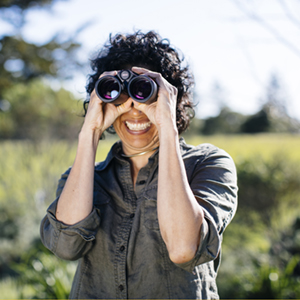 person looking through binoculars